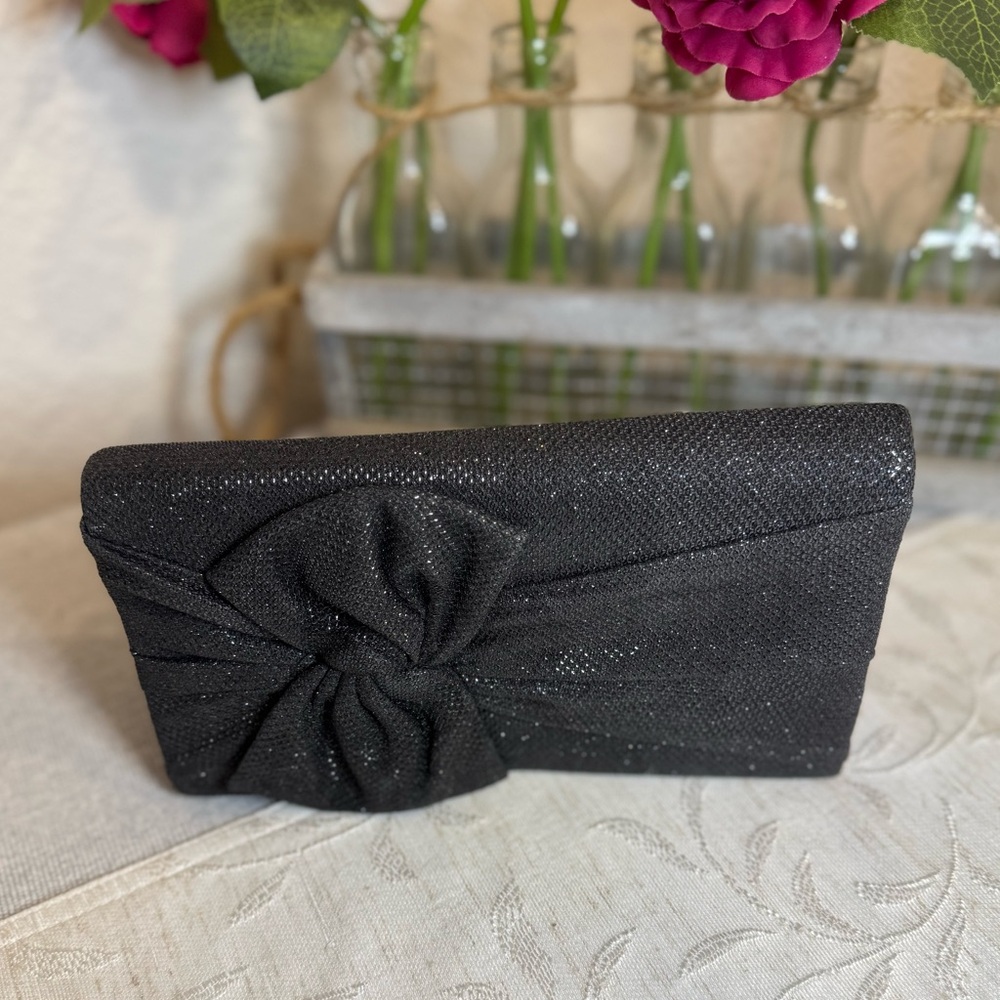Style & Co black shimmery evening clutch bag with a bow detail. 8”x 4.5” x 1.5”
